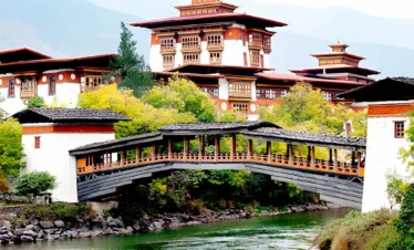 Punakha Dzong in Bhutan with traditional bridge and riverside setting under clear sky