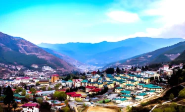 Panoramic view of Thimphu city in Bhutan with traditional buildings, mountain valley, and clear blue sky