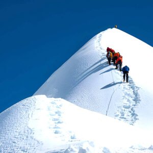 Island Peak expedition in Nepal with climbers ascending a snow and ice ridge in the Everest region of the Himalayas.