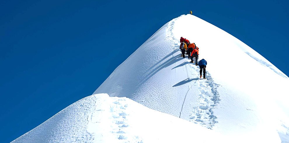 Island Peak expedition in Nepal with climbers ascending a snow and ice ridge in the Everest region of the Himalayas.