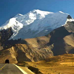 Kharola Glacier in Tibet, a dramatic high-altitude glacier descending from Himalayan peaks near Karola Pass along the Friendship Highway.