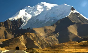 Kharola Glacier in Tibet, a dramatic high-altitude glacier descending from Himalayan peaks near Karola Pass along the Friendship Highway.