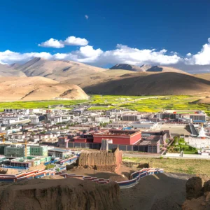 Sakya Village in Tibet with traditional Tibetan houses and Sakya Monastery set against the high plateau landscape.