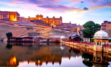 Amber Fort in Jaipur reflected in Maota Lake at sunset, Rajasthan, India