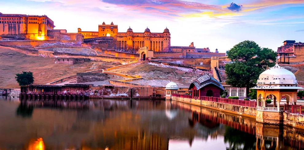 Amber Fort in Jaipur reflected in Maota Lake at sunset, Rajasthan, India